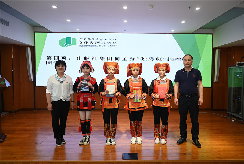 廣西師范大學(xué)出版社集團副總裁、工會(huì )主席莫曲波（右一）代表出版社向金秀“獨秀班”同學(xué)贈送圖書(shū)（李顯楊攝）.jpg